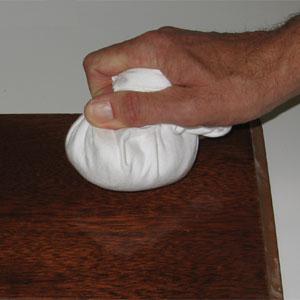 Applying French polish with a pad.
