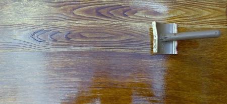 Creating a faux good grain using a graining rocking tool and wood stain.
